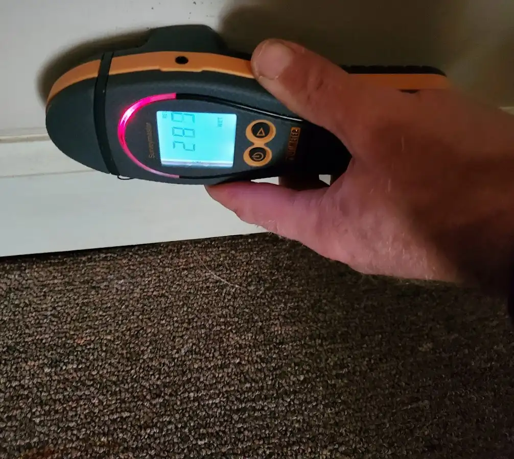 Moisture detection at baseboard during Storm Damage Restoration in Coolbaugh